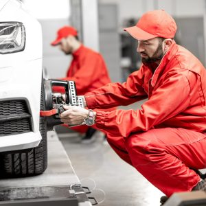 auto-mechanics-making-wheel-alignment-at-the-car-service.jpg